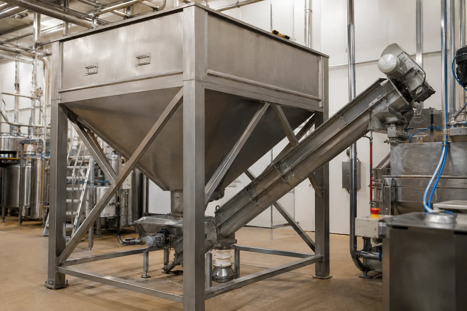 Stainless steel surge bin and screw feeder system for cocoa powder handling in a manufacturing facility